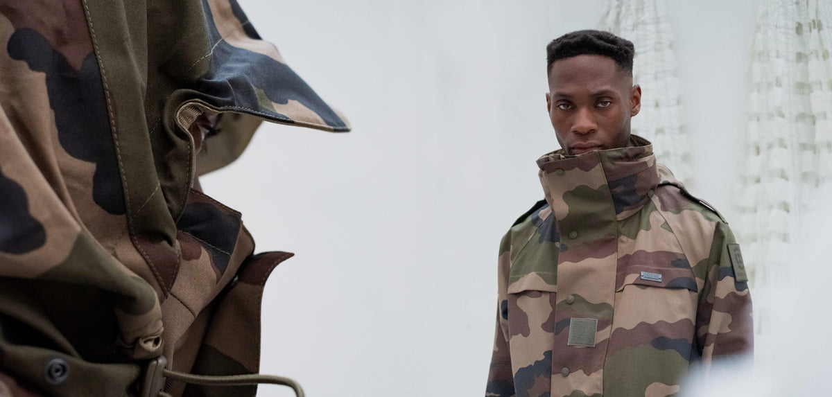 Model in a camouflage military parka from RÆFOUND by Christopher Ræburn.