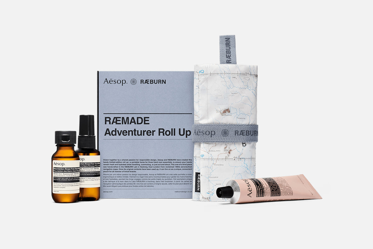 Aesop × RÆBURN RÆMADE Adventurer Roll Up, made from a reclaimed navigation map, with its box and Aesop hand care products